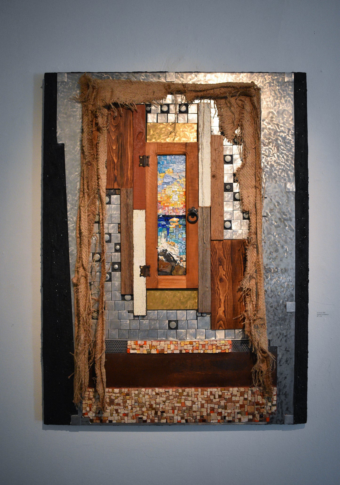 Artistic mosaic artwork of a window overlooking the sea.
