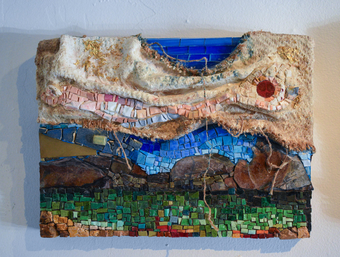 Mosaic artwork with natural elements and textiles