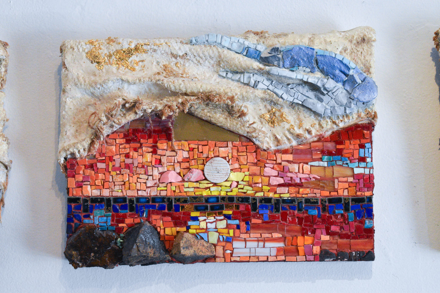 Mosaics sunset artwork with colorful patterns on a textured surface