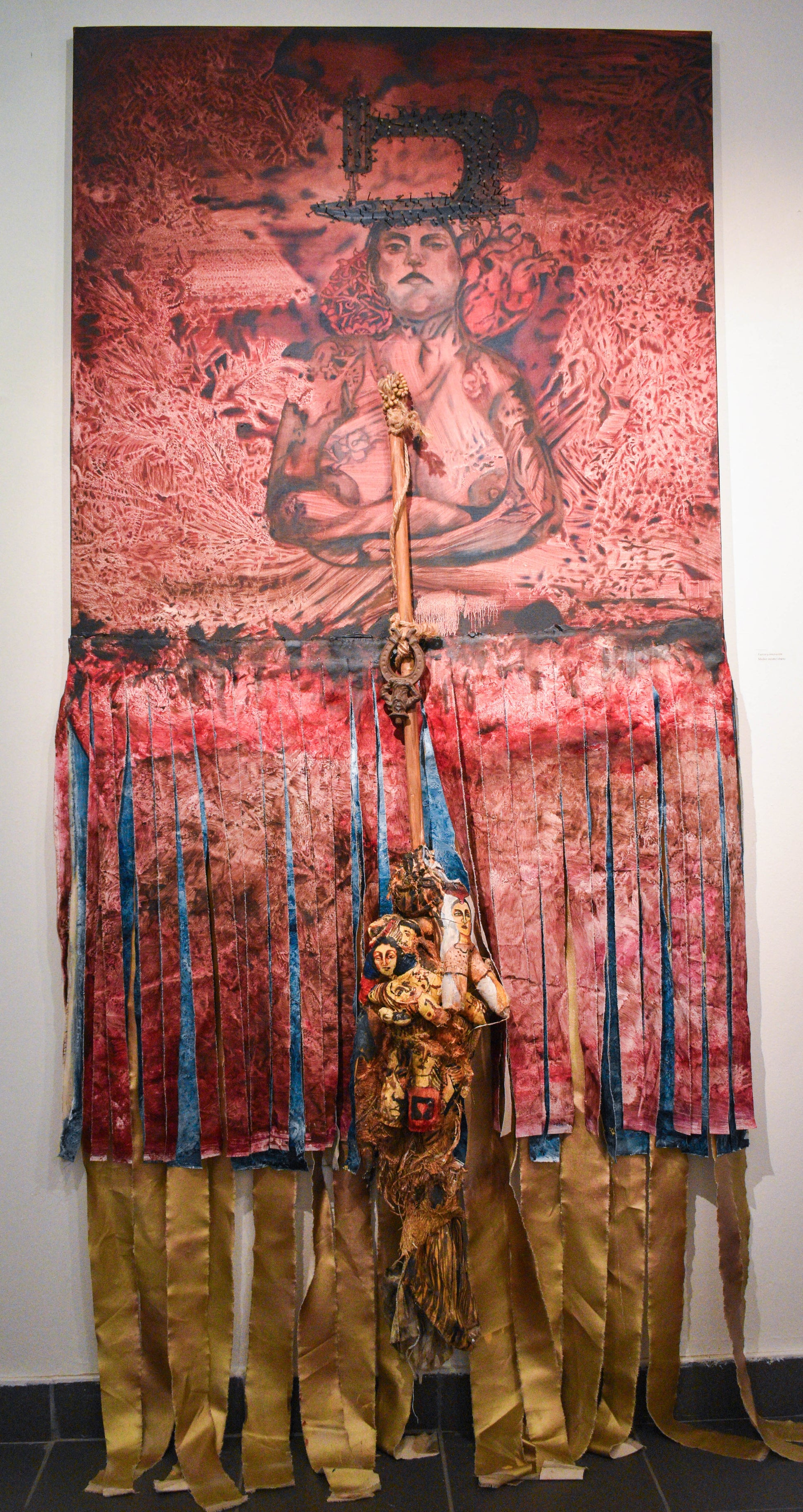 Mixed media art piece with a central woman figure and decorative elements.