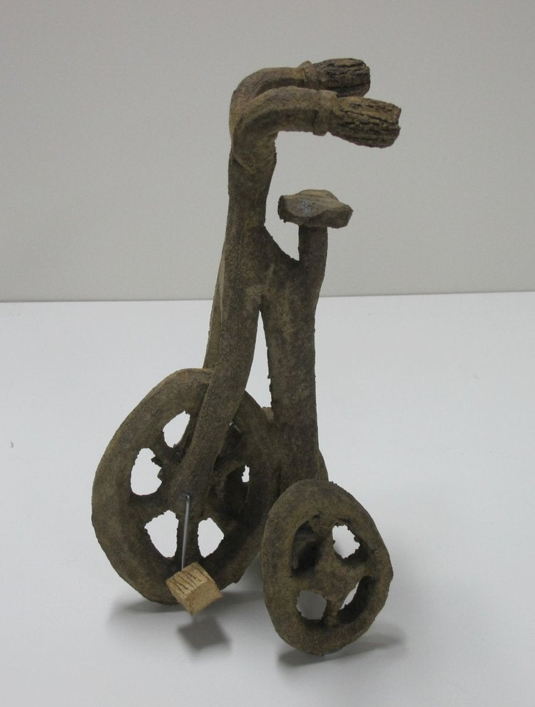 A ceramic sculpture of a miniature bicycle with a rustic, brown finish.