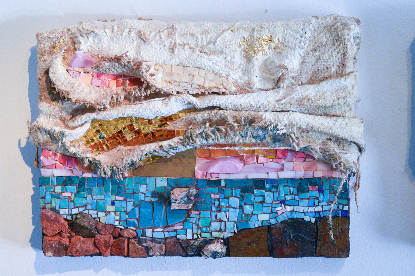 Multicolored sunset mosaic art piece with textiles