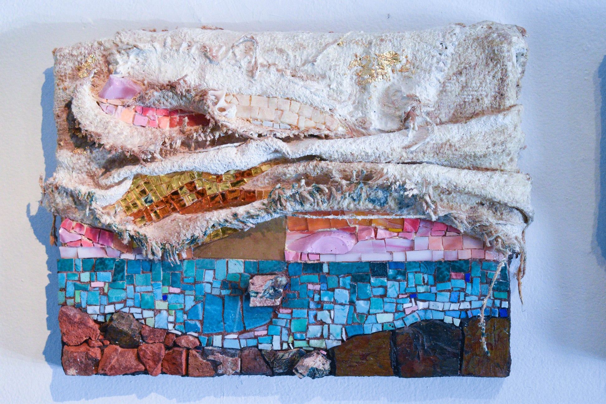 Multicolored sunset mosaic art piece with textiles